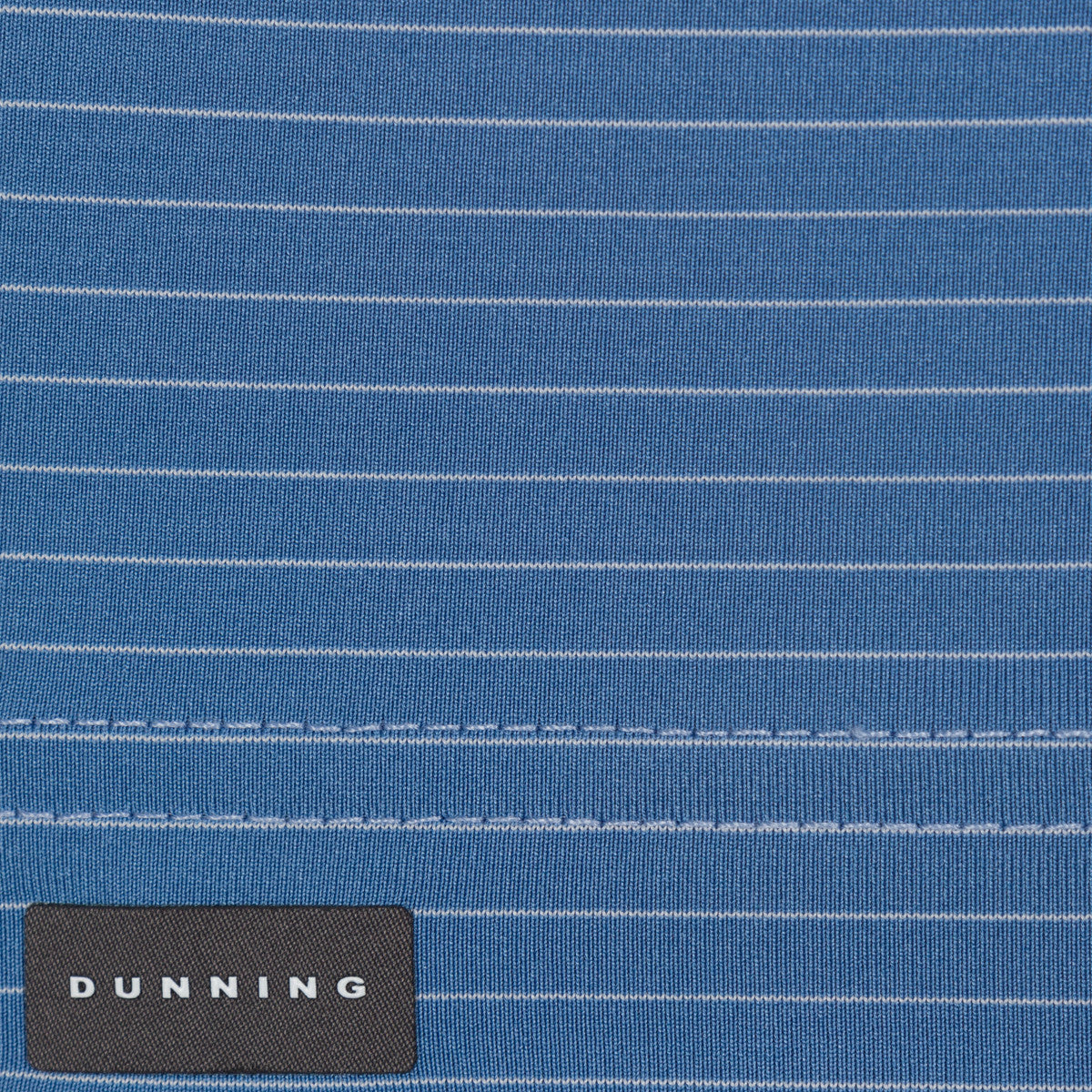 Close-up of a blue striped fabric with a Dunning label.