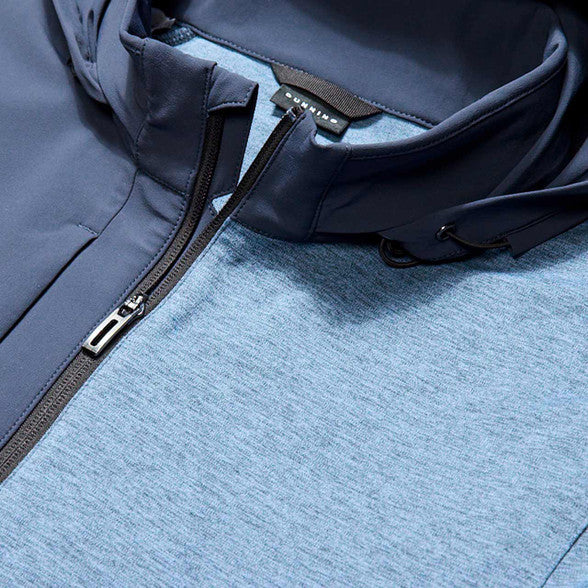 Close-up of a blue jacket with a zipper on a textured surface
