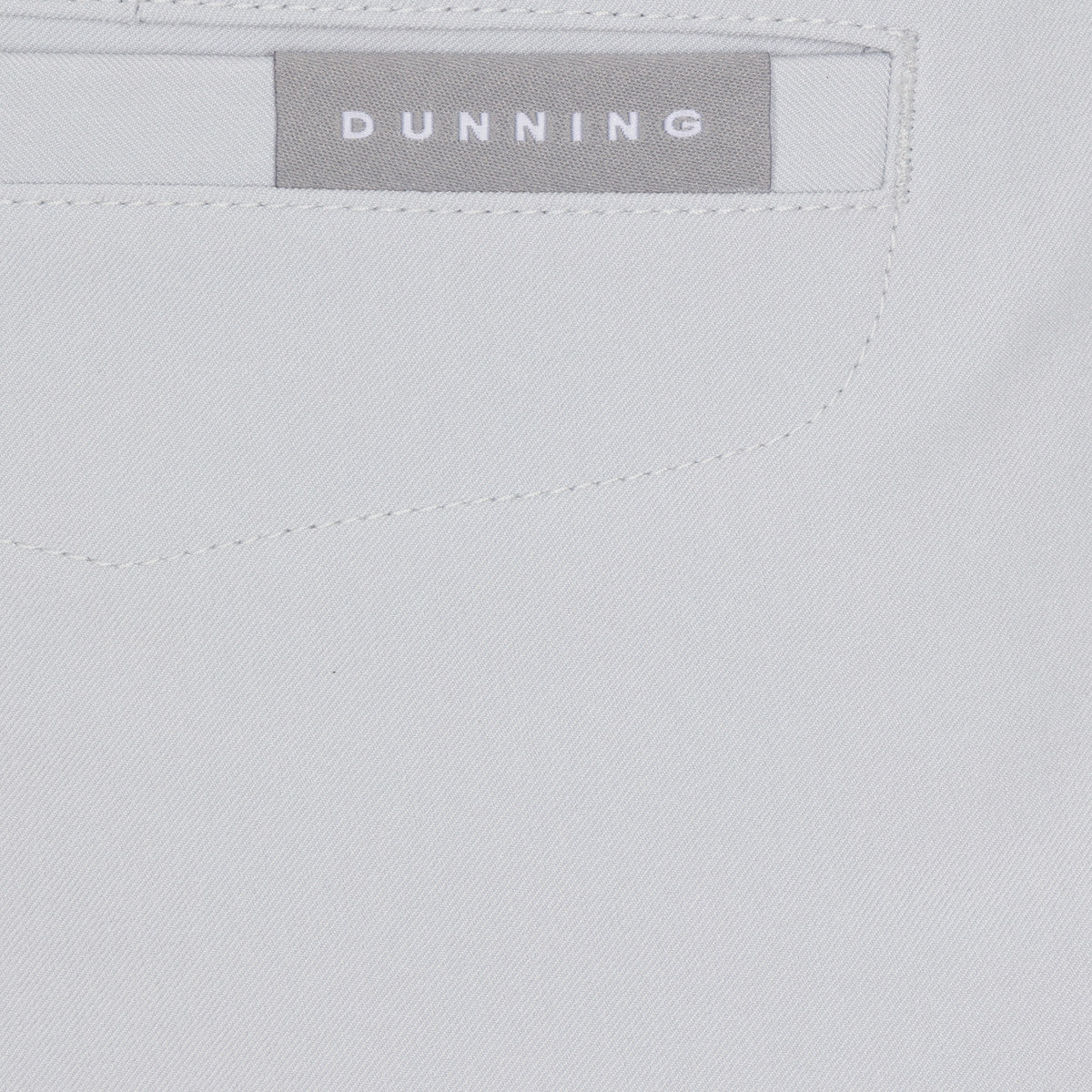 Close-up of a gray fabric with 'Dunning' branding label.