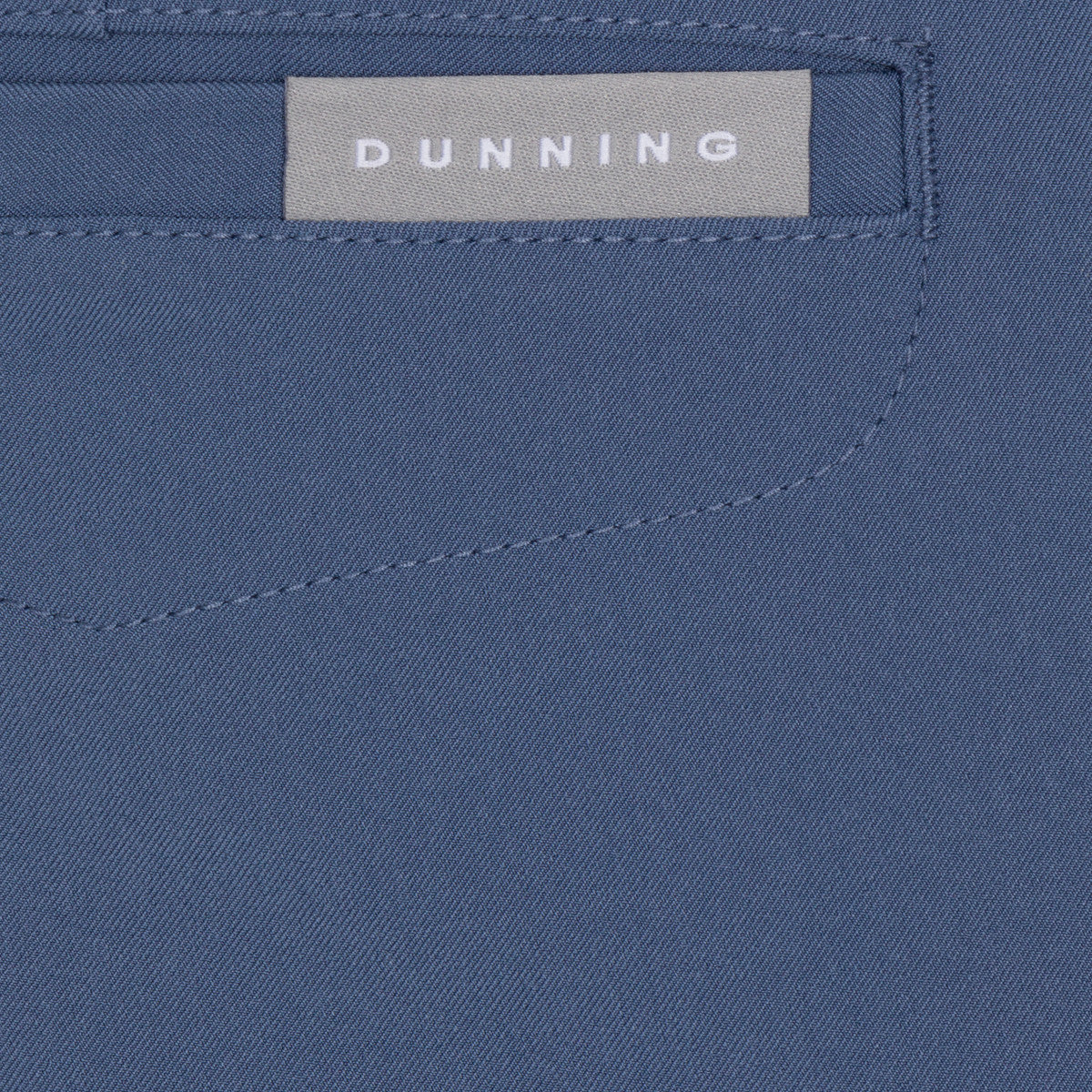 Close-up of a blue fabric with a 'Dunning' label.