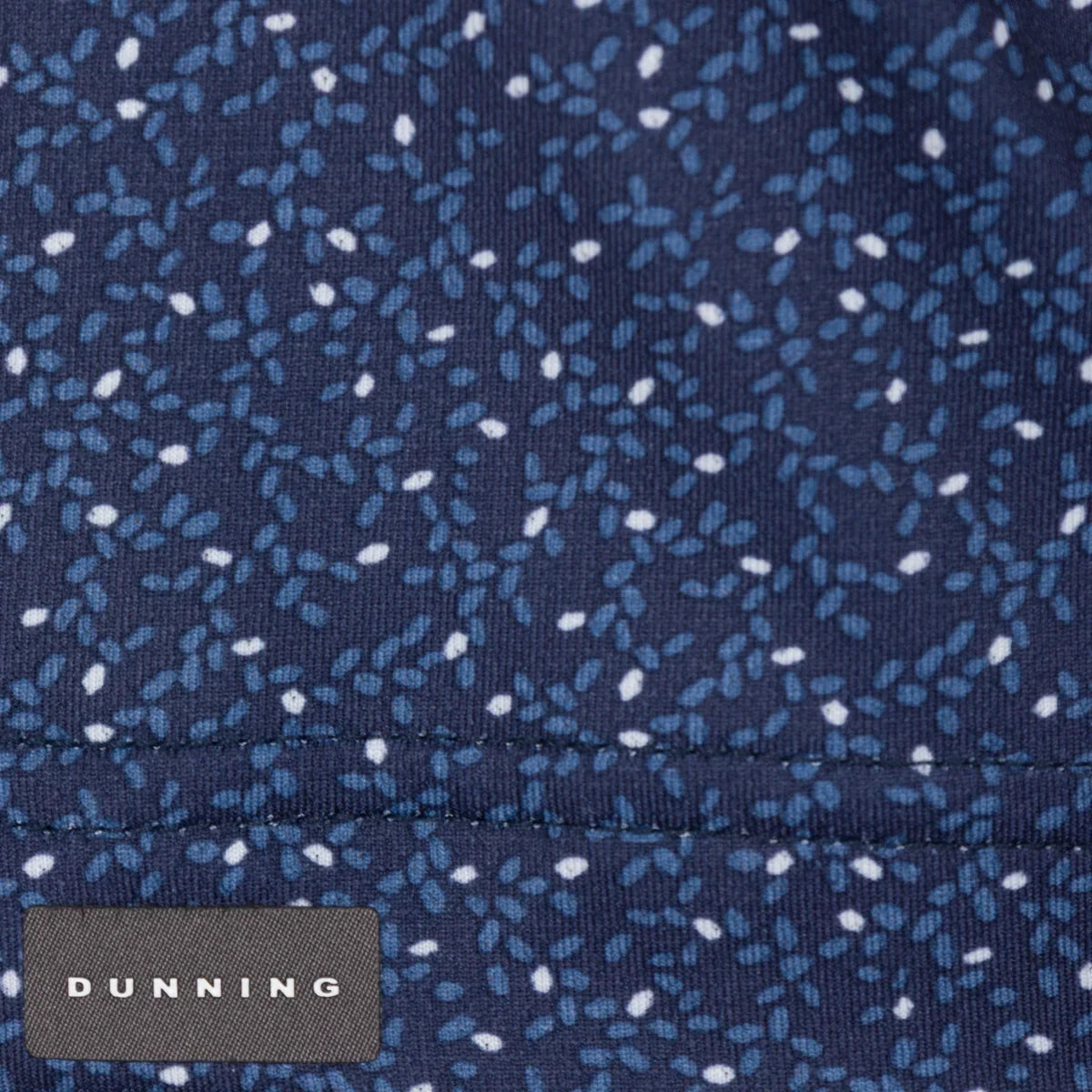 Boyd Ventilated Performance Polo navy print fabric and Dunning label close-up