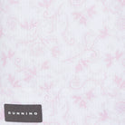 Bennett Ventilated Performance Polo pink botanical print on white fabric with Dunning label, close-up