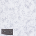 Bennett Ventilated Performance Polo grey botanical print on white fabric with Dunning label, close-up