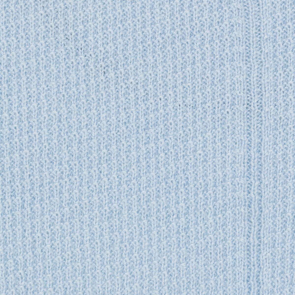 Close-up of a textured light blue fabric surface
