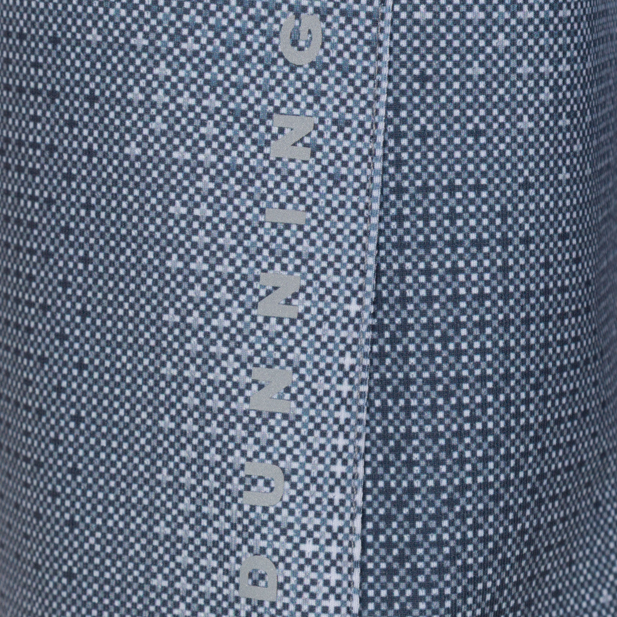Close-up of a blue denim fabric with 'Quiksilver' branding.