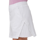White pleated skirt worn over a pink top on a white background