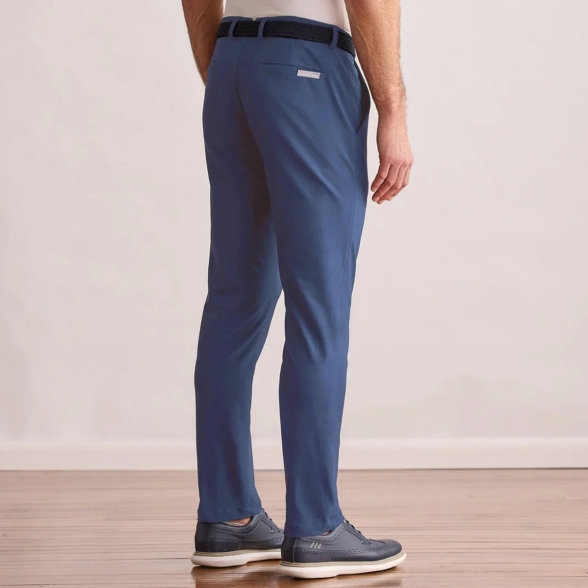 Modern Player Fit Performance Pant in vintage indigo, back view on model