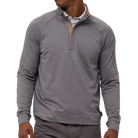 Man wearing a gray half-zip pullover on a white background