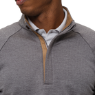 Gray quarter-zip sweater with brown trim worn by a person