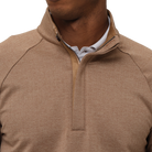 Close-up of a brown quarter-zip pullover with a white shirt underneath on a white background